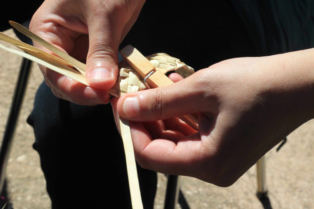 hands-weaving-palm-leaves