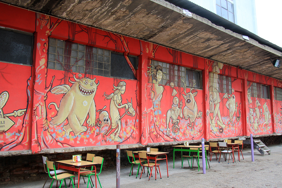 red wall with drawing of figures