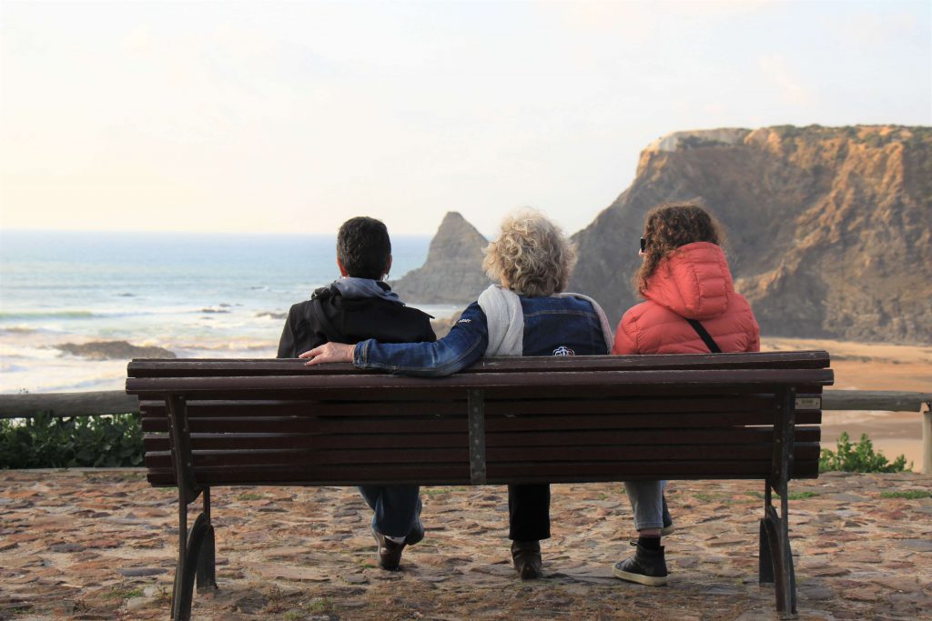 women seating watching the sea